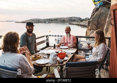 Friends having meal on patio Stock Photo