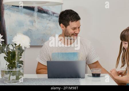 Father and daughter using laptop Stock Photo