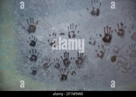 Hand imprints on frosty glass Stock Photo