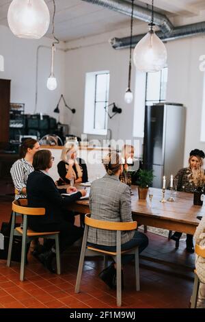 Female coworkers having meeting in cafe Stock Photo