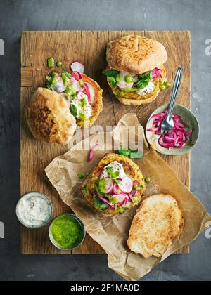 High angle view of burgers on wooden board Stock Photo