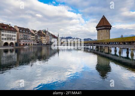 View of the Kapellbrücke bridge and the Wasserturm from the rathaussteg reflected on the Reuss river. Lucerne, canton of Lucerne, Switzerland. Stock Photo