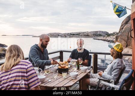 Friends having meal on patio Stock Photo