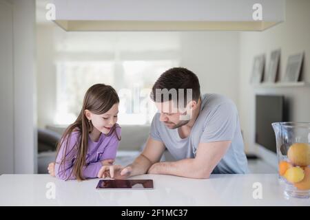 Father and daughter using digital tablet Stock Photo