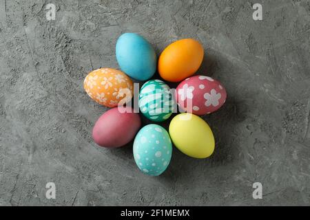 Beautiful multicolor Easter eggs with patterns on a gray concrete background, top view Stock Photo