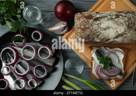 Shots of vodka and tasty snacks on wooden table, top view Stock Photo
