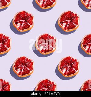 Photography collage of pomegranate on pastel purple lavender color background top view. Isometric food pattern Stock Photo