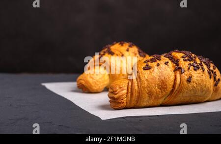 Croissants with chocolate on a dark background Stock Photo
