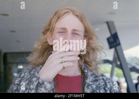 Berlin, Germany. Portrait of a young adult blonde male with long hairdue. Stock Photo