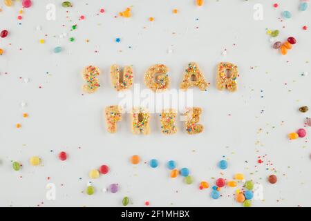Sugar free inscription made of unsweetened cookies and colorful sprinkles around Stock Photo