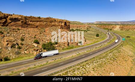 Vehicle Traffic moves along a Divided Highway in southwestern Desert Country Stock Photo