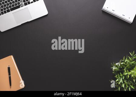 Workspace with laptop, office supplies. Stylish table desk, image with copy space on black background Stock Photo