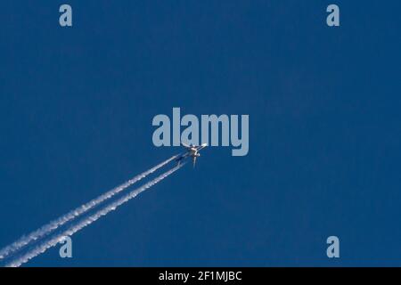 A Boeing 777-FS2 operated by Federal Express (Fed-Ex) leaves a vapour trail as it flies over Kanagawa, Japan. Stock Photo