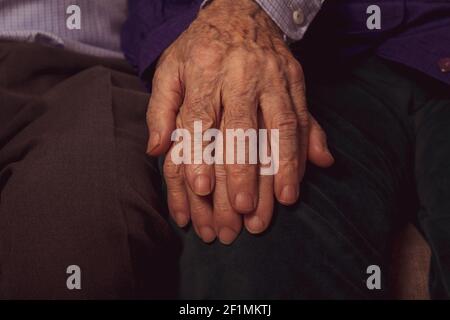 Aged hands. Support in old marriage couple. Elderly helping hands. Healthcare in old age. Seniors support and care of each other.  Stock Photo