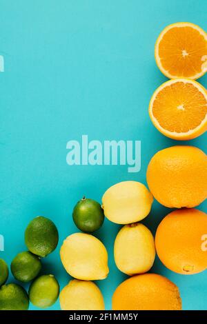 Juicy delicious oranges, lemons and limes on light blue background Stock Photo
