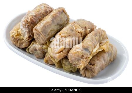 Cabbage wrap appetizer (mezze) isolated on white background. Healthy vegan food. Local name lahana sarması Stock Photo