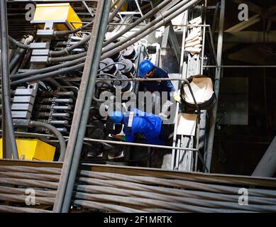 Khromtau/Kazakhstan - May 06 2012: Copper ore concentration plant. Maintenance workers and equipment. Stock Photo