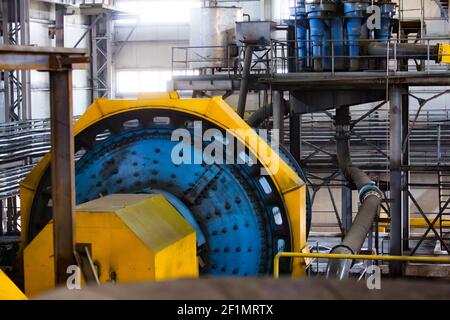 Khromtau/Kazakhstan - May 06 2012:  Blue and yellow factory ball mill. Copper ore concentration plant. Stock Photo