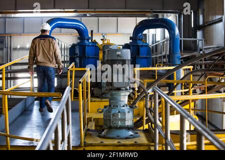 Khromtau/Kazakhstan - May 06 2012: Copper ore concentration plant. Maintenance workers and pumping equipment. Stock Photo