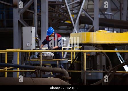 Khromtau/Kazakhstan - May 06 2012: Copper ore concentration plant. Maintenance workers and pumps equipment. Stock Photo