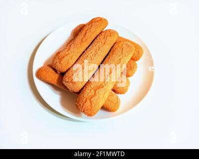 Sweet soft healthy soft spongy sprinkled sugar vanilla cookies (vainillas). Classic Argentine biscuits. White background. High angle shot. Stock Photo