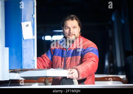 Portrait of a middle-aged working man in a dirty jacket. Stock Photo