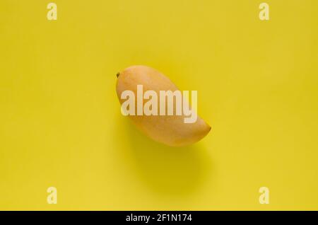 Ripe yellow Thailand barracuda mango on yellow background. Stock Photo