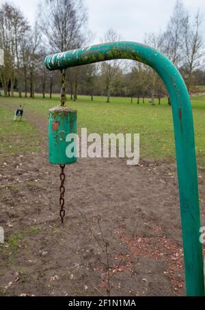 Green warning bell hanging from  a metal support at the point where a footpath crosses Wetherby Golf Course Stock Photo