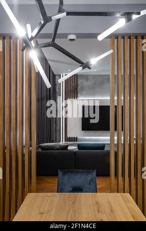 View from kitchen to living room in luxury private house. Modern interior. Wooden design. Stock Photo