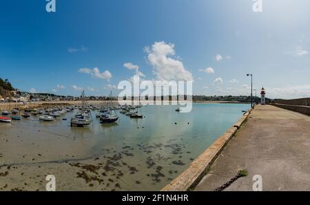 The old harbor and lighthouse of Erquy in Brittany Stock Photo