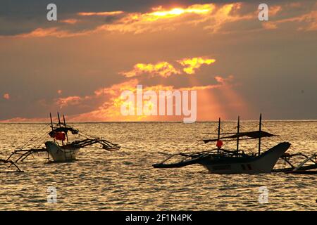 Two Traditional Fishing Boats with Cloudy Sunset Stock Photo