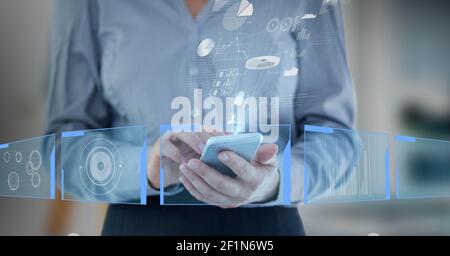 Digital interface with data processing over mid section of businesswoman using smartphone Stock Photo