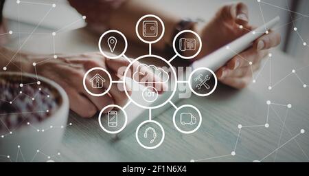 Network of digital icons and network of connections against person using digital tablet Stock Photo