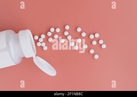 topview of methyl folate tablets flying from the jar. dietary concept. dietary supplement close-up Stock Photo
