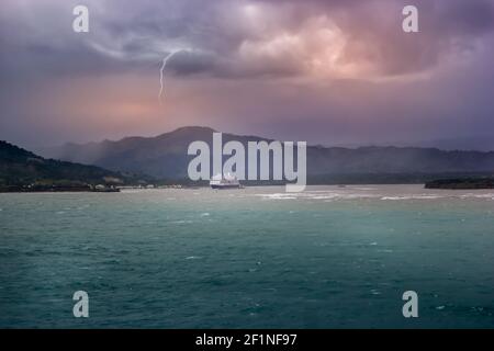 Storm clouds over a cruise ship in the Caribbean sea Stock Photo