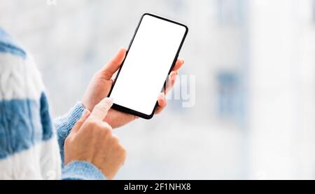 Hand holding mobile phone with white screen Stock Photo
