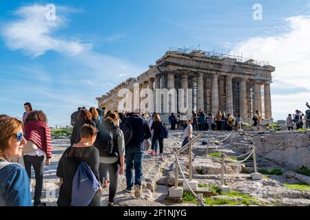 Athens-Greece, November 23, 2019: Many visiting people at the Parthenon Acropolis. Historical marble parts and Hellenistic, Greek columns Stock Photo