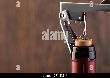 Corkscrew and bottle of wine Stock Photo