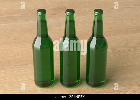 Three beer bottles 500ml mock up on wooden background. Side view Stock Photo