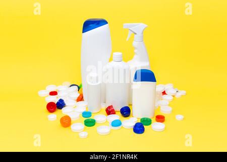 Different plastic containers isolated on yellow background. Recycling concept. Space for text. Stock Photo