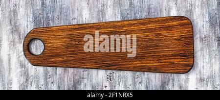 Cutting board on a wooden table Stock Photo