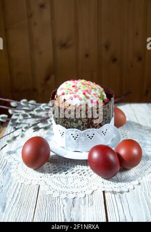 Easter cake on a lace napkin surrounded by painted eggs. Copy space. Stock Photo