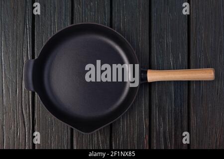 Empty frying pan on wooden background Stock Photo