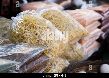 Typical Turkish hand made pasta or noodles packed in transparent plastic bags. Stock Photo