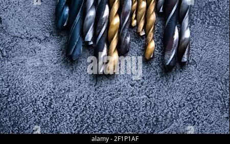 Different sizes drill bits on grey background with copy space Stock Photo