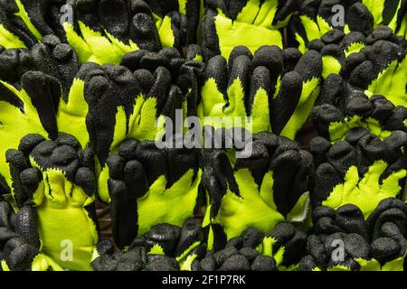 top view of yellow and black, rubberized textile work gloves Stock Photo