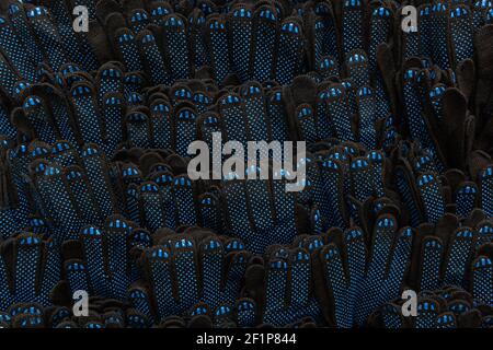 background of black work gloves with blue rubberized dots, top view Stock Photo