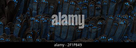 background of identical, black and blue rubberized work gloves, top view, banner Stock Photo