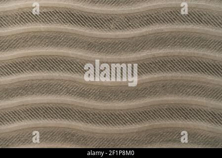 grey, cement textured surface, with horizontal wavy lines, top view Stock Photo