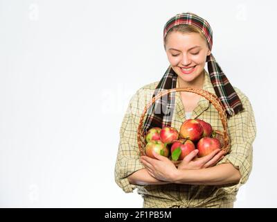 Woman gardener rustic style hold basket with apples on white background. Lady farmer gardener know how cook many recipes with apples. Cook recipe concept. Woman villager carry basket natural fruits. Stock Photo